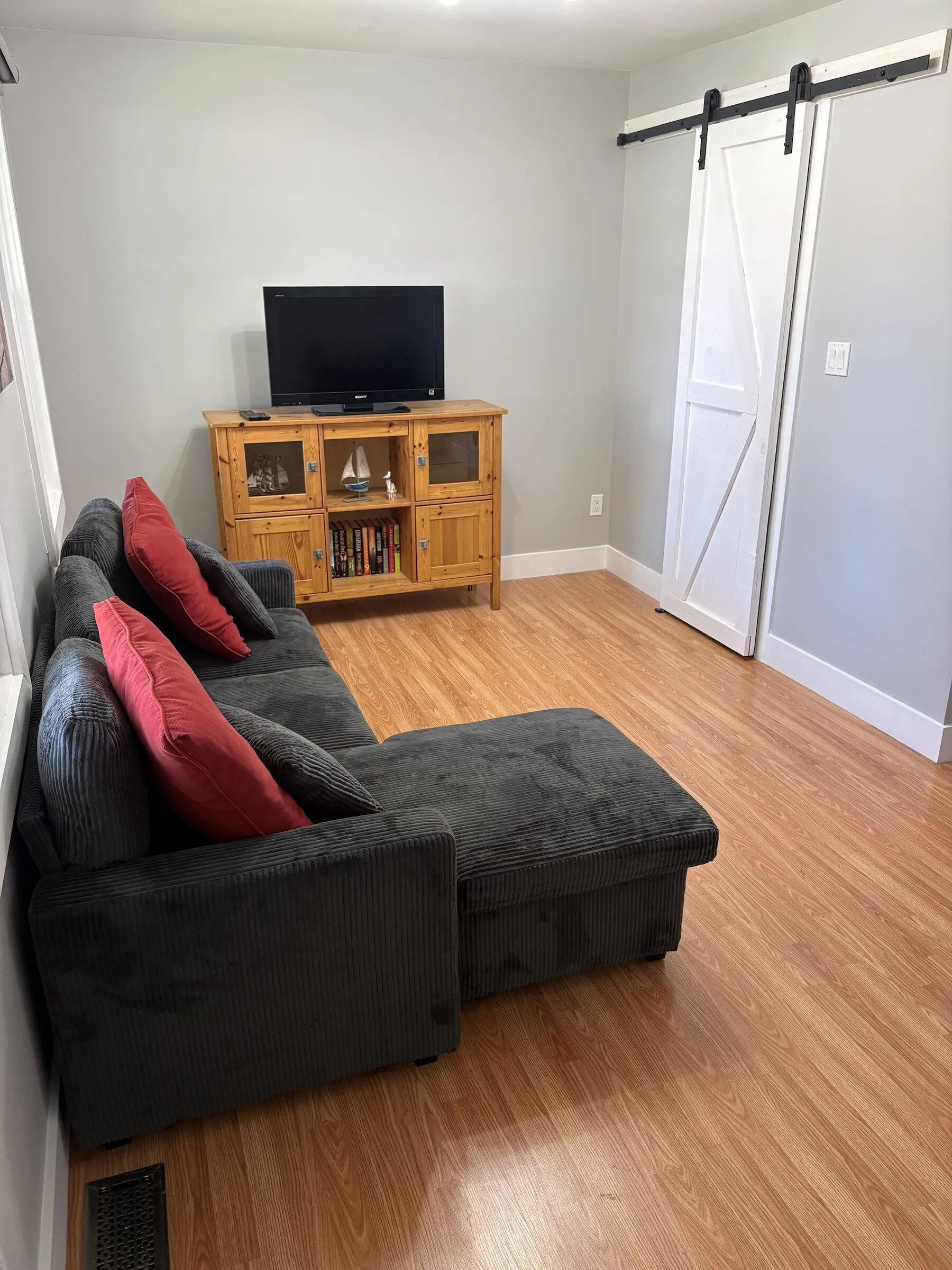 Living room with sectional, TV and bookshelf