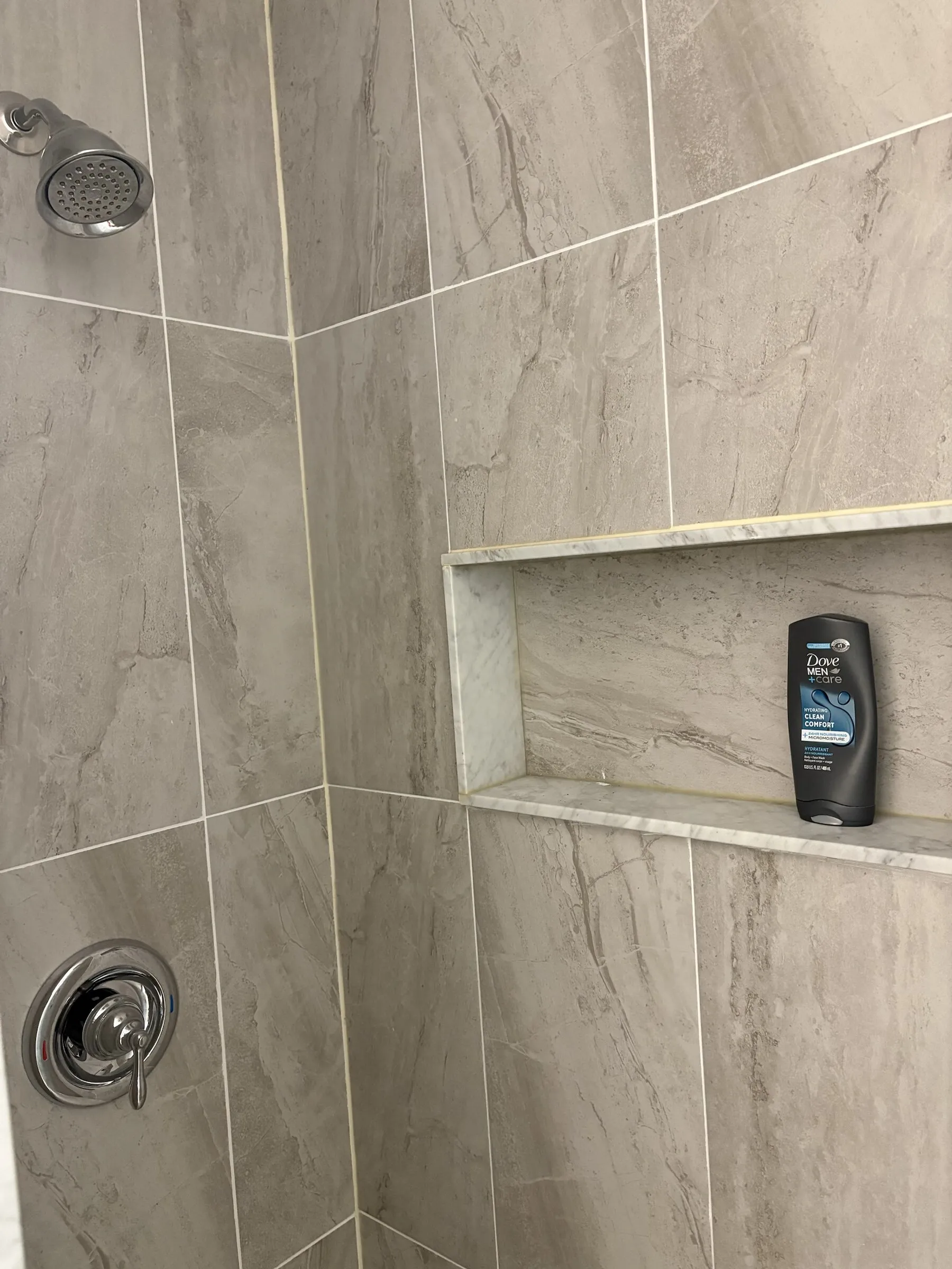 Tiled walk-in shower with niche